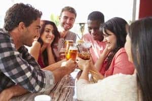 group of friends enjoying drink at outdoor rooftop bar, taphunter