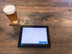 pint of beer and square pos on an ipad