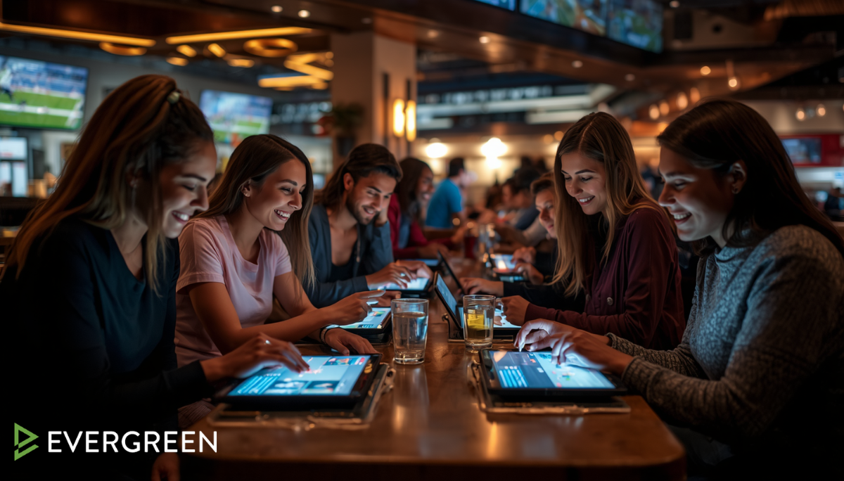 customers engaged and smiling while using touchscreen tablets for ordering food, drinks, and playing interactive games