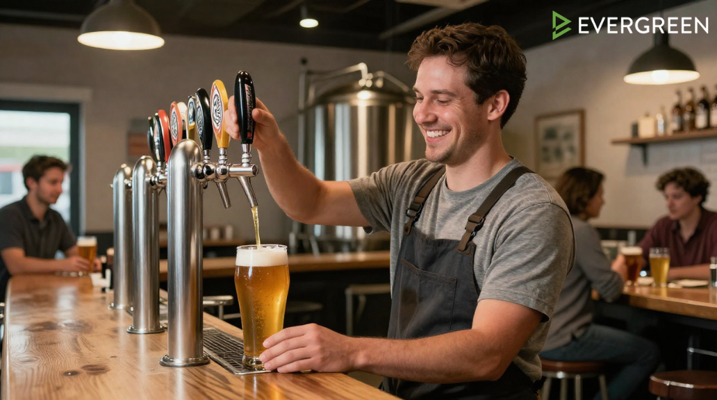 American craft brewery employee smiling while serving a freshly poured beer at a modern brewery taproom
