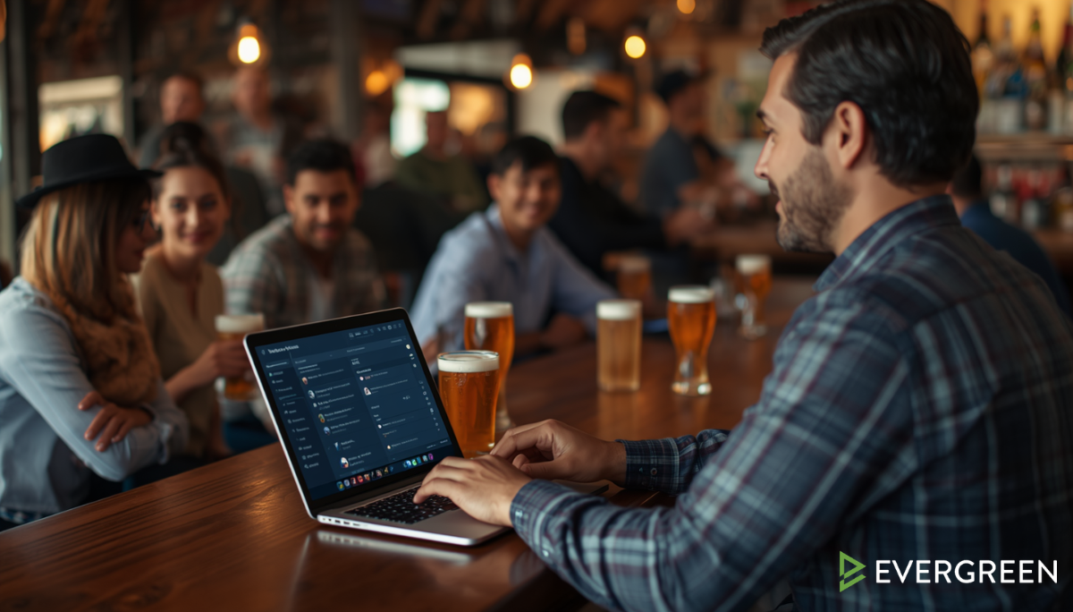 bar owner reviewing customer feedback and social media comments on a laptop