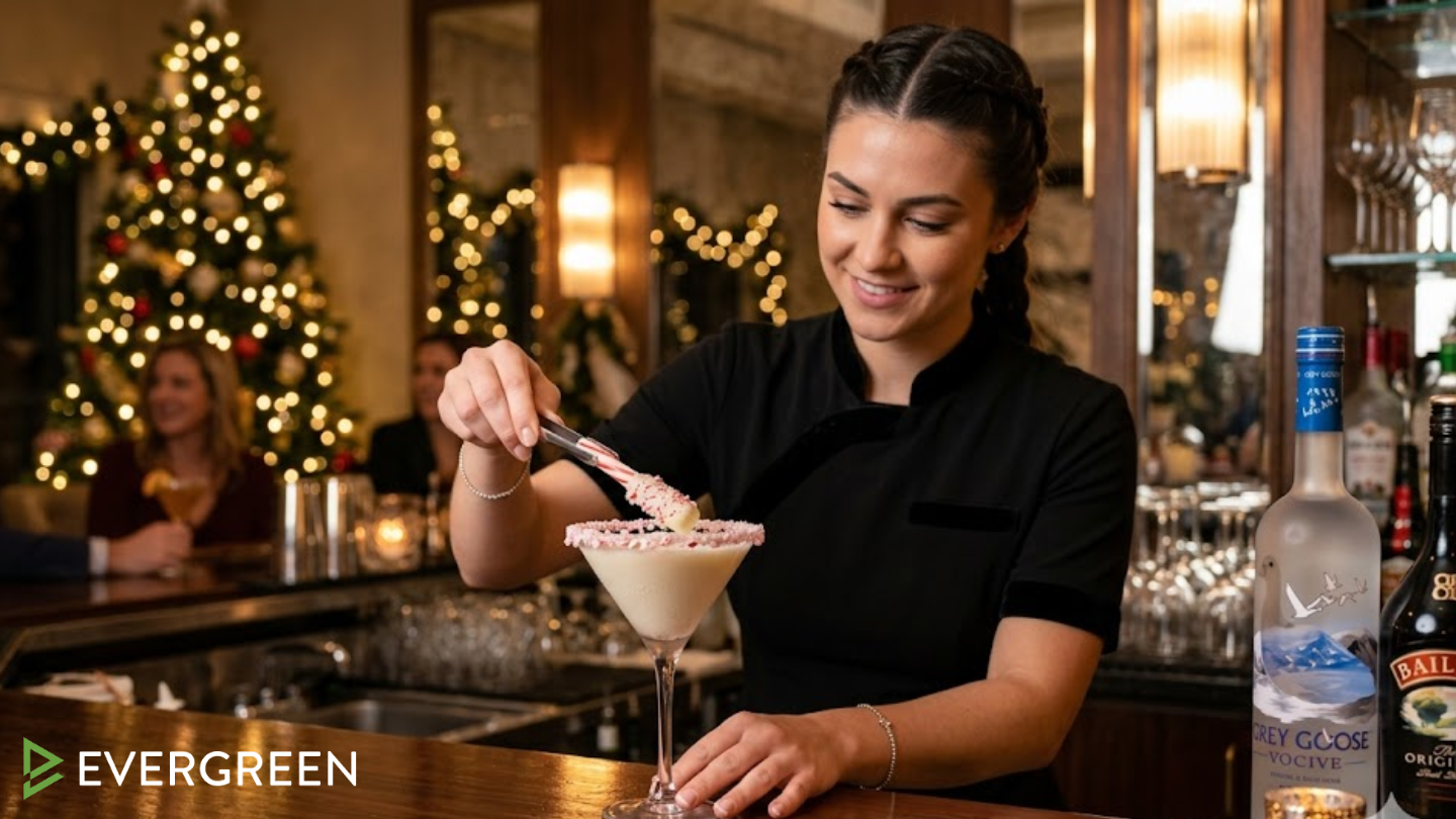 A professional American female bartender in a sleek black uniform is delicately placing a peppermint stick garnish dipped in white chocolate into a martini glass
